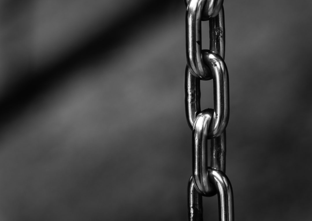 Chain links on blurred gray background