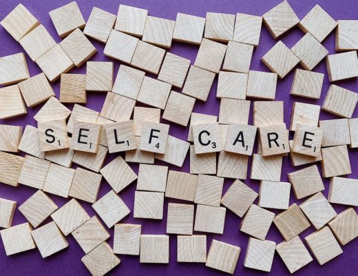 Scrabble tiles spelling out self care